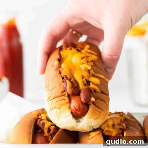 A deliciously assembled chili cheese dog, ready to be enjoyed.