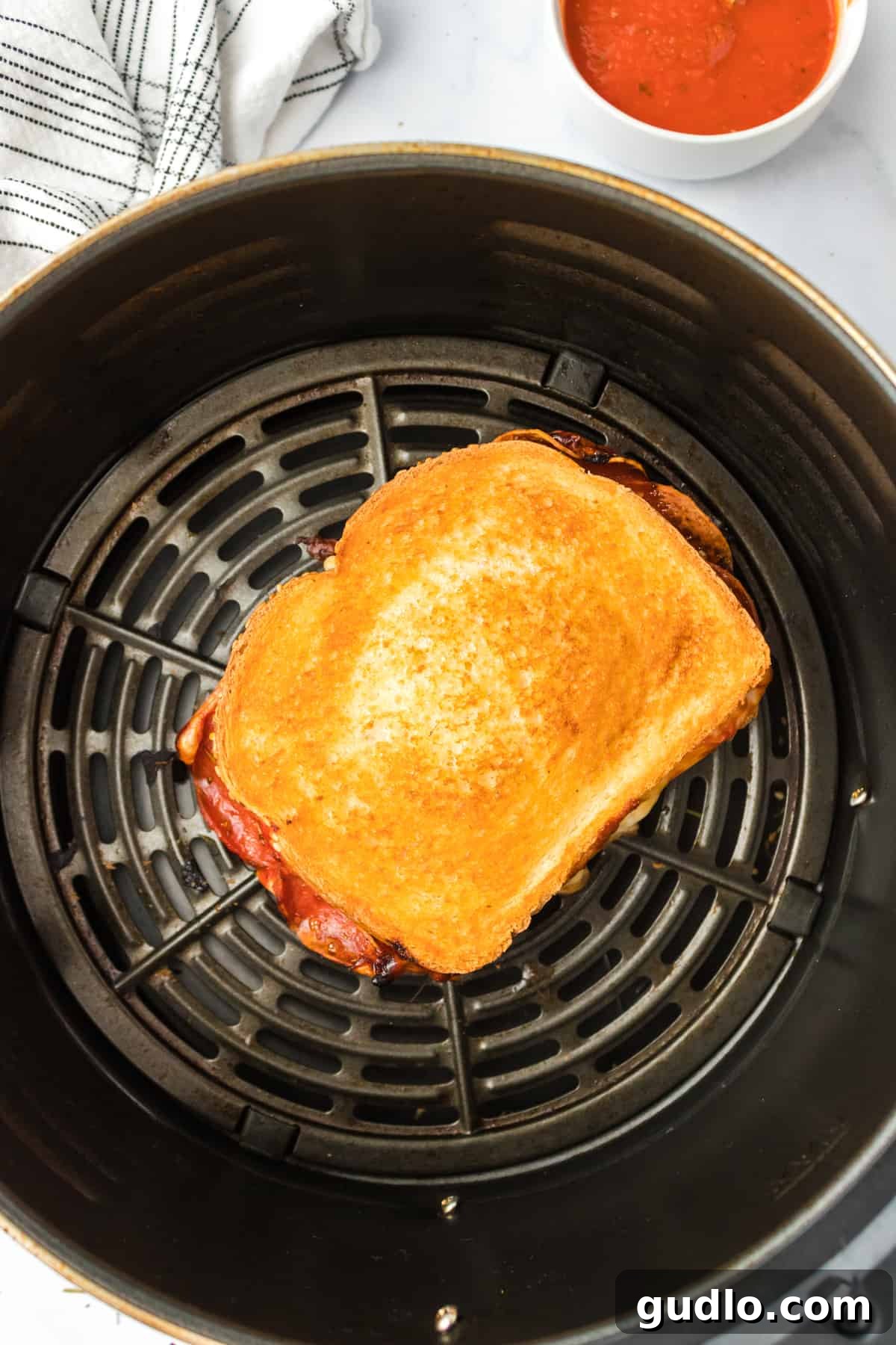 Air Fryer Pizza Grilled Cheese cooking. Grilled cheese cooking to perfection inside an air fryer.