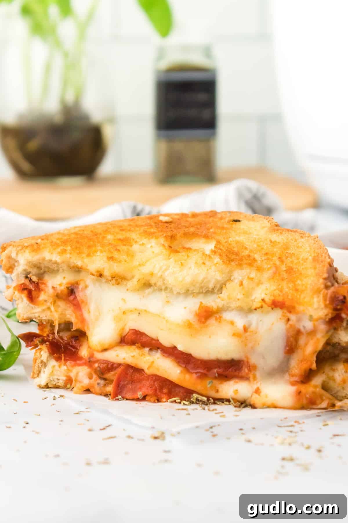 Stacked Air Fryer Pizza Grilled Cheese. Several Air Fryer Pizza Grilled Cheese sandwiches stacked on top of each other, showcasing their layers.