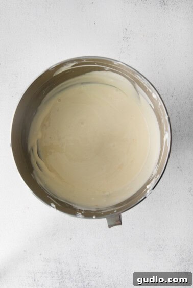 Smooth, creamy cheesecake batter in a mixing bowl, perfectly blended and ready for baking.