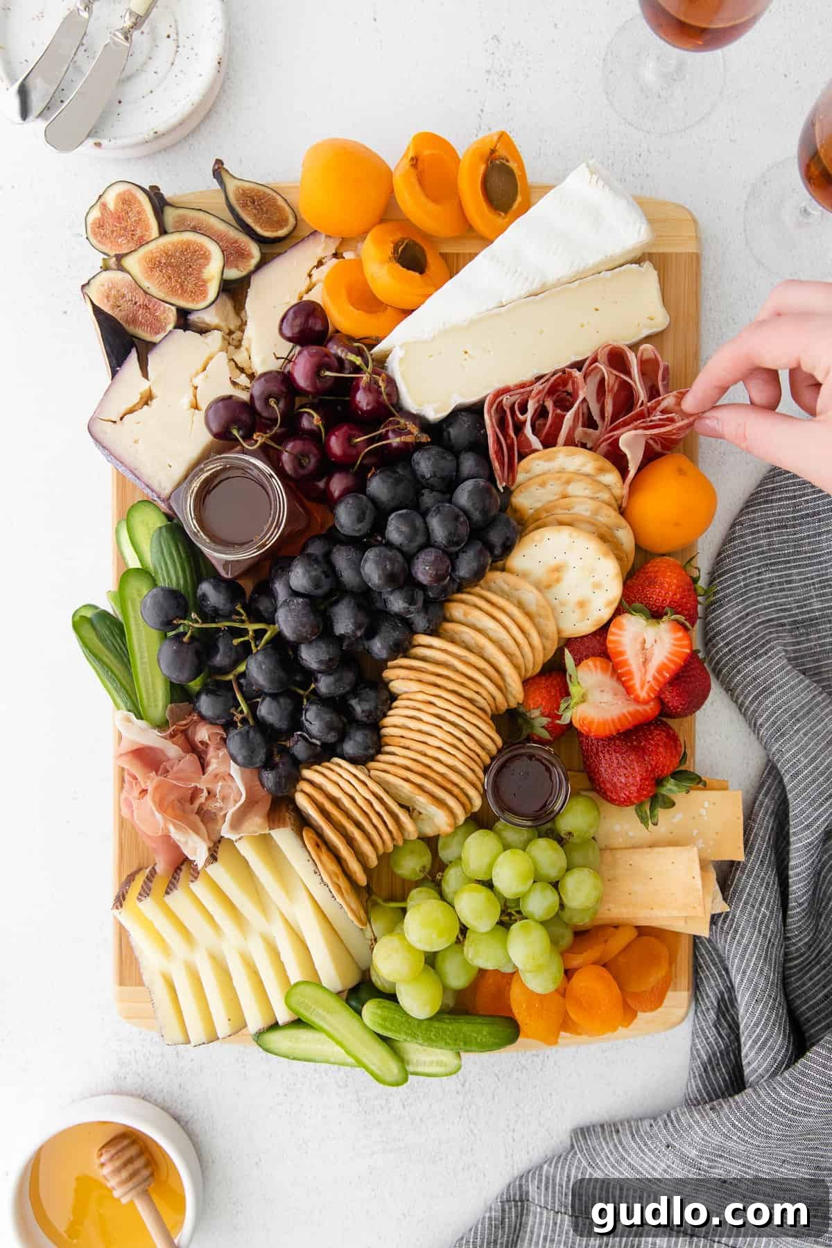 Craft Your Perfect Cheese Board with Our Easy Guide A vibrant cheese board generously filled with various cheeses, meats, crackers, and fresh fruit on a rustic cutting board, ready for sharing.