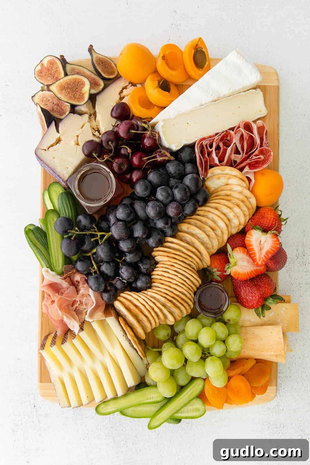 Artfully Arranged Charcuterie Board for Entertaining A rustic charcuterie board generously laden with cheeses, cured meats, fresh and dried fruits, nuts, and crackers, appealing to all tastes.