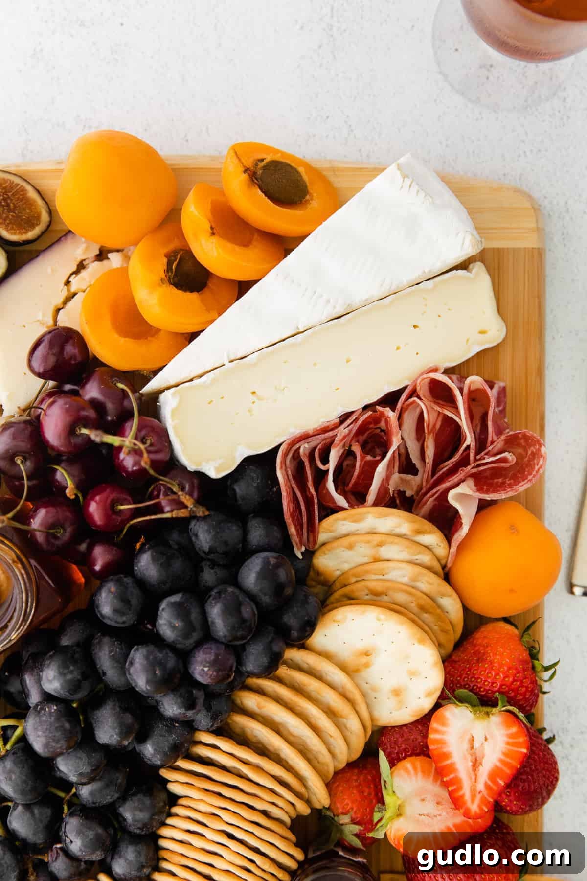 The Ultimate Cheese Board for Any Gathering An inviting cheese board, beautifully arranged with various cheeses, a generous bunch of grapes, and an assortment of crackers and nuts.