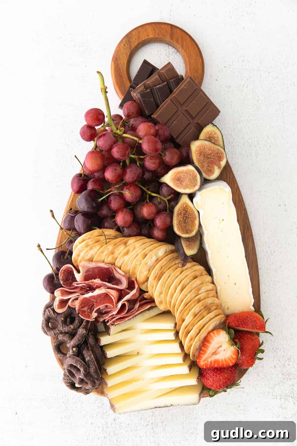 A completed, lush chocolate and cheese board, ready for guests to enjoy.
