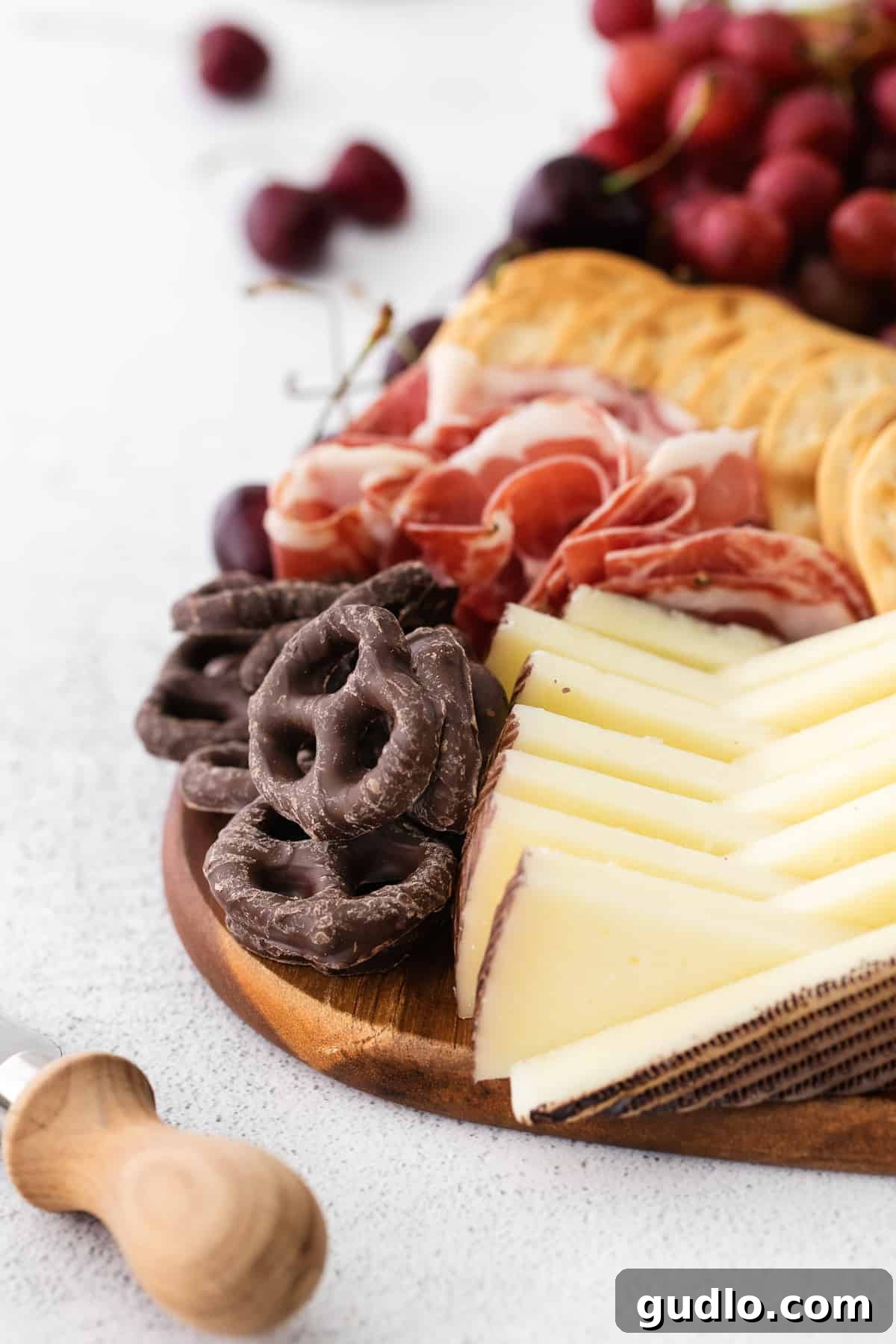 A close-up view of a chocolate and cheese board, highlighting the intricate arrangement of various components.