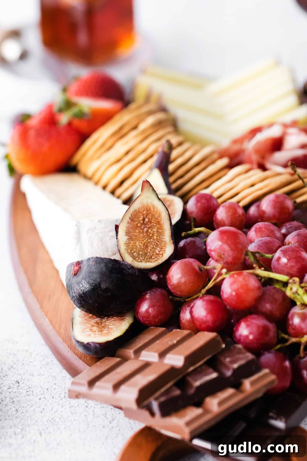 Close-up of fresh figs, beautifully arranged on a chocolate and cheese board.