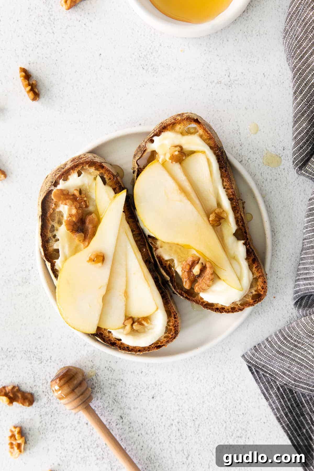 Ricotta Toast: Sweet and Savory Delights 2 Ricotta toast with pears and walnuts on top.