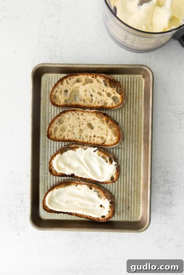 Ricotta Toast: Sweet and Savory Delights 11 Four slices of bread with ricotta toast on a baking sheet.