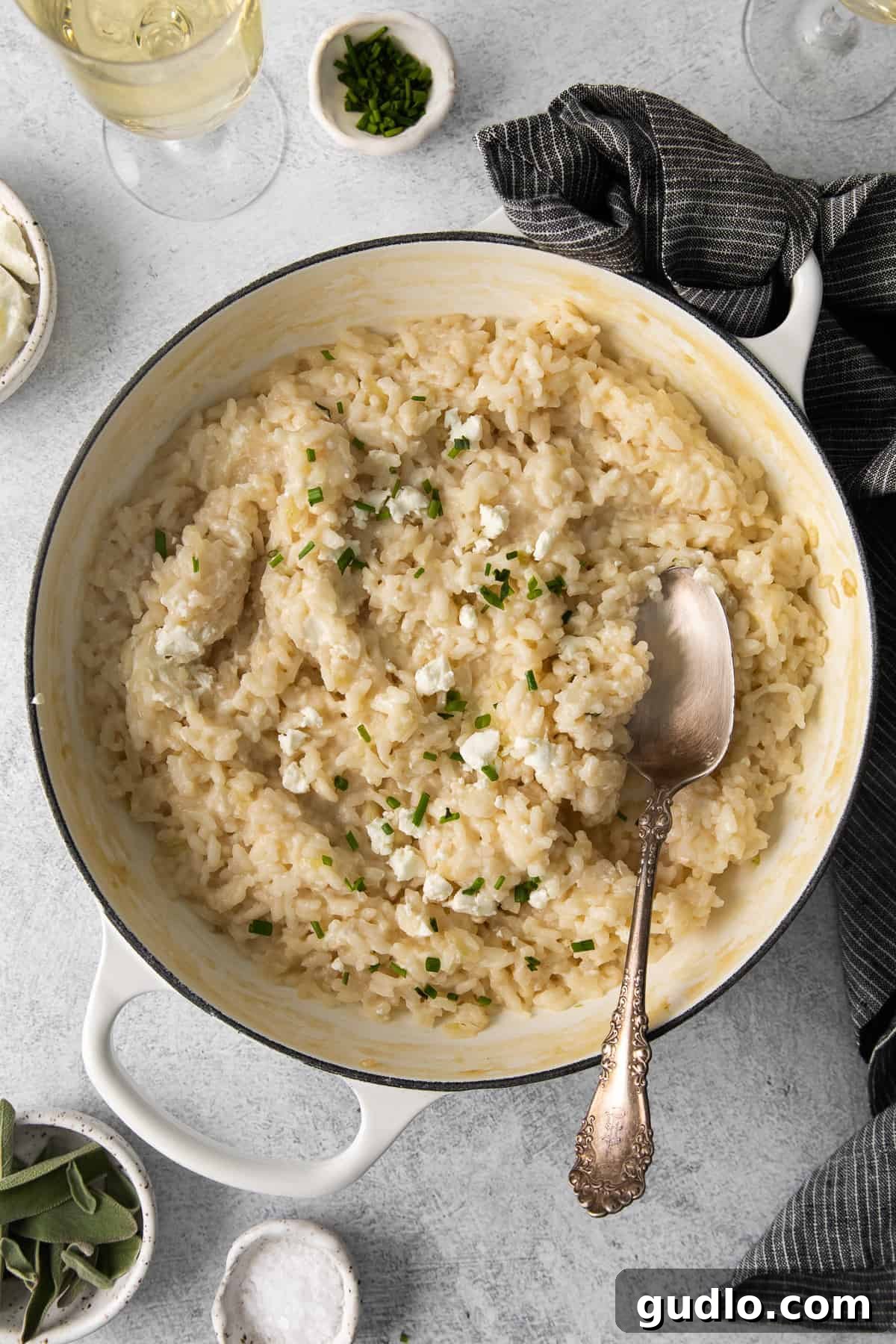 Delicious creamy goat cheese risotto in a serving dish. A beautifully plated creamy goat cheese risotto, garnished with fresh herbs, ready to be served.