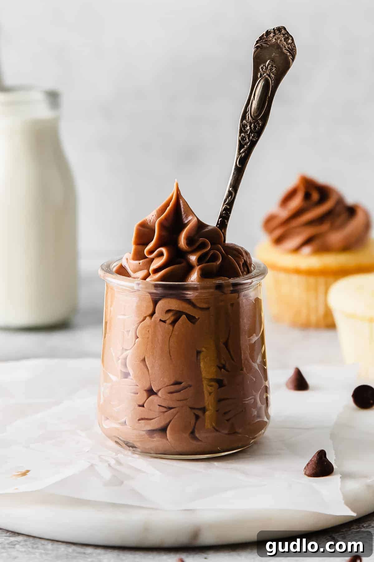 Velvety Chocolate Cream Cheese Delight 2 Rich and creamy chocolate cream cheese frosting in a glass jar, ready to be used on desserts. This sweet frosting is made with cream cheese, butter, and chocolate.