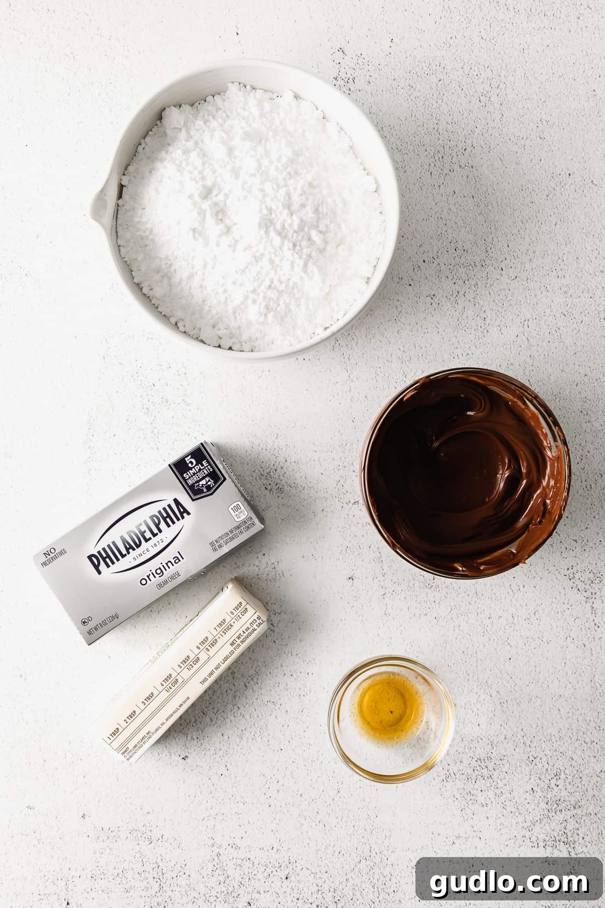 Velvety Chocolate Cream Cheese Delight 3 All five key ingredients for chocolate cream cheese frosting laid out on a surface: cream cheese, butter, powdered sugar, semi-sweet chocolate, and vanilla extract. You only need these 5 ingredients to make this delicious chocolate cream cheese frosting.