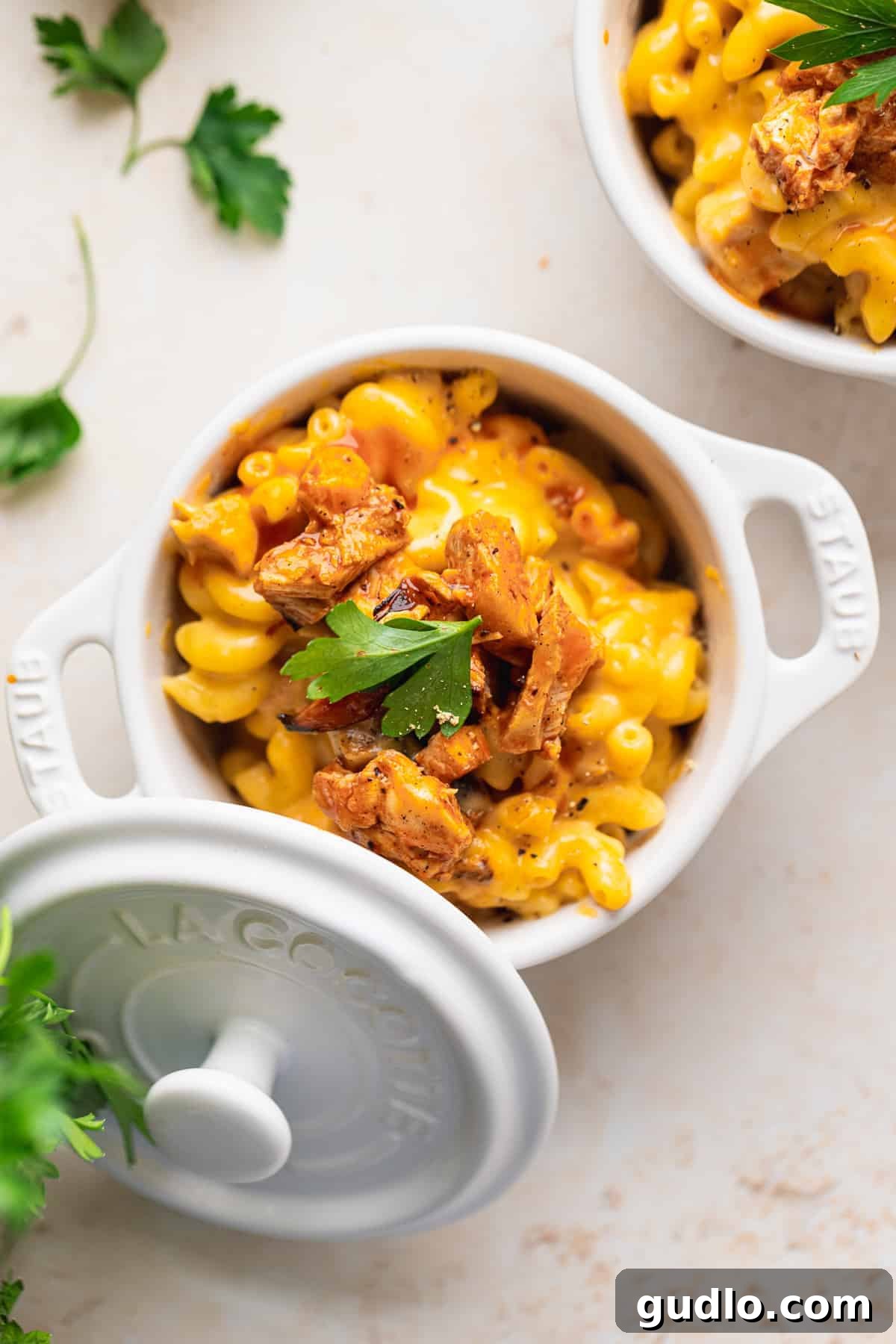 A beautifully composed close-up of Buffalo Chicken Mac and Cheese in a bowl, showing the creamy texture, golden noodles, and tender chicken pieces, ready for digging in.