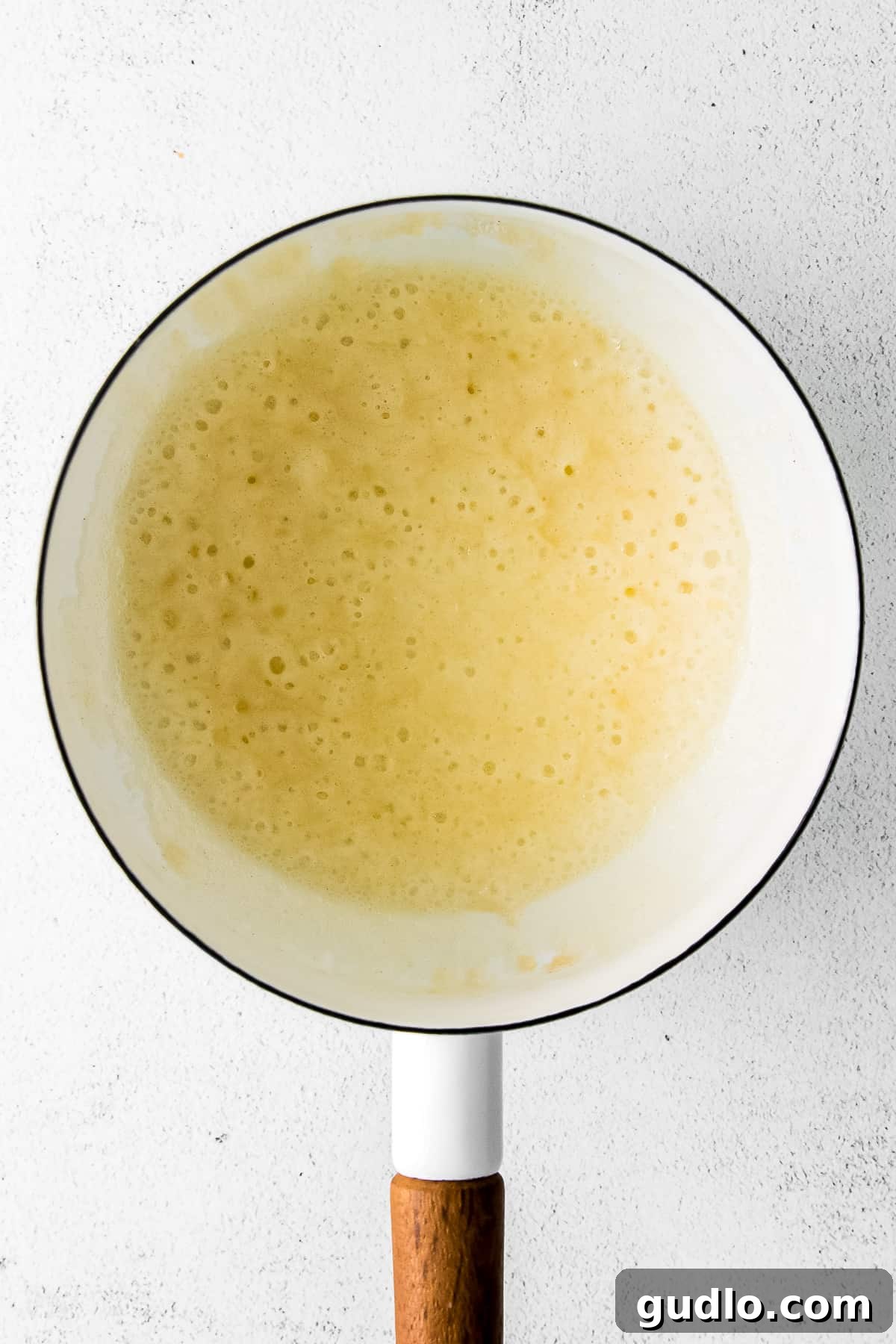 Creamy Beer Cheese Fondue 5 Stages of making a roux: melted butter, flour added, and then milk being whisked in to create a smooth, thickened base for the beer cheese dip.
