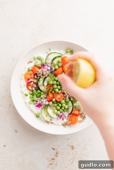Wholesome Cottage Medley 5 A person adding lemon juice to a cottage cheese salad.
