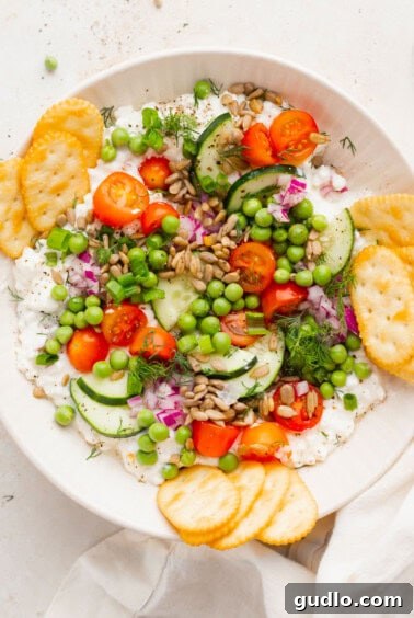 Wholesome Cottage Medley 6 Cottage cheese salad in a white bowl, garnished with sunflower seeds and fresh herbs, ready for serving.