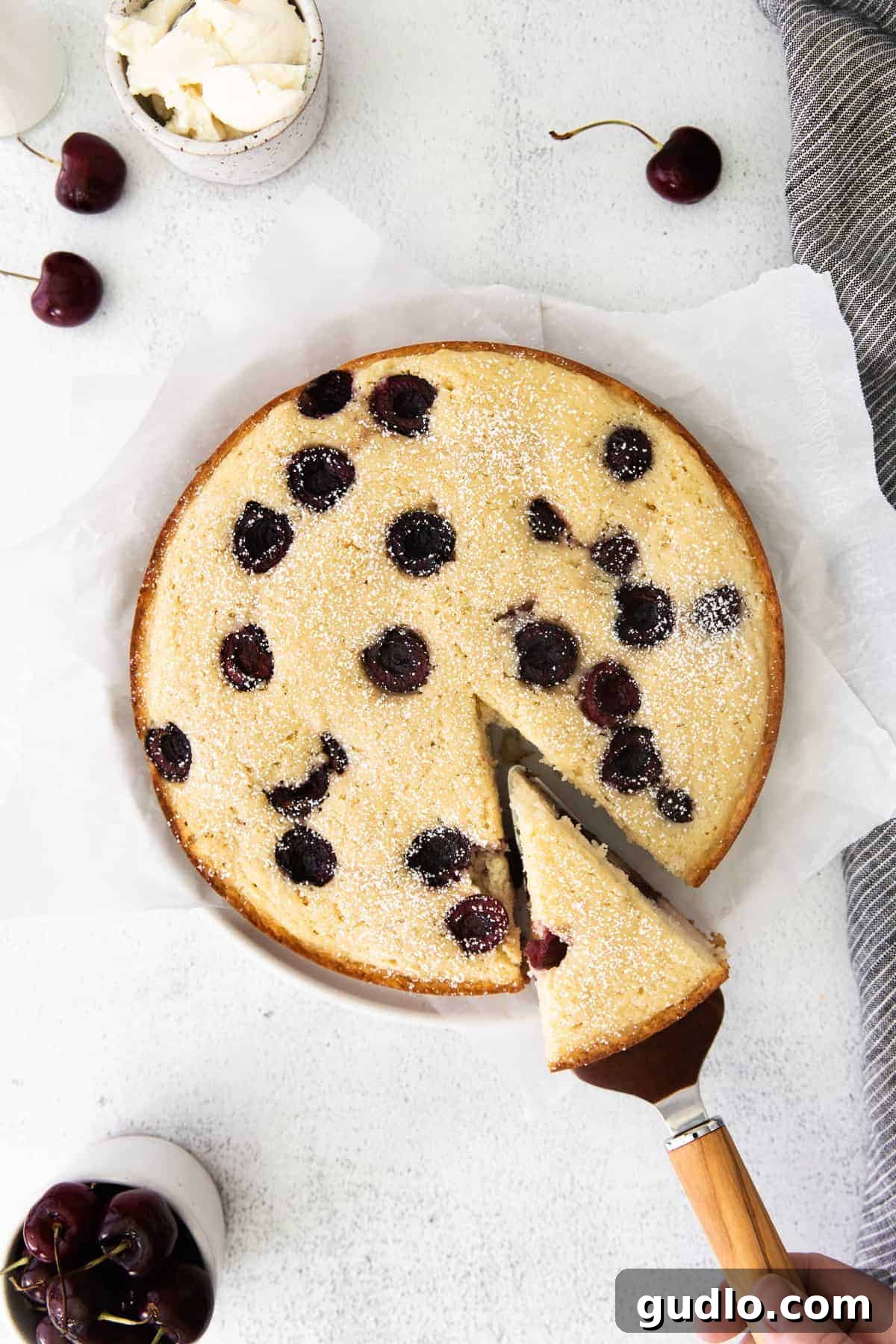 Velvety Cherry Ricotta Bliss 2 A beautifully baked Cherry Ricotta Cake, golden brown with visible red cherries, sitting on a kitchen counter.
