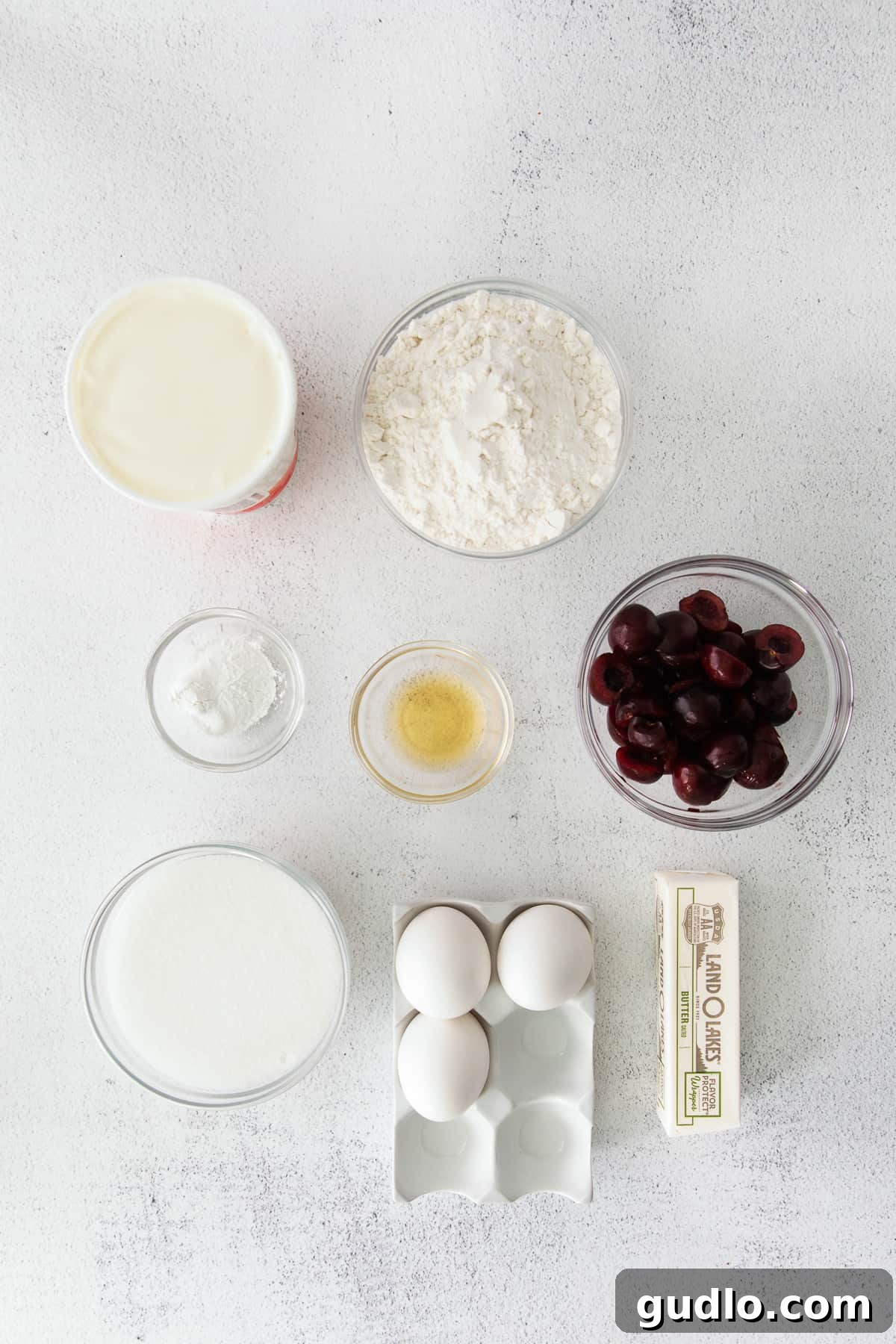 Velvety Cherry Ricotta Bliss 4 All the fresh ingredients laid out for making a delicious Cherry Ricotta Cake, including bing cherries, ricotta, and flour.