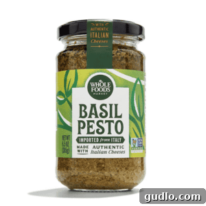 Vibrant Pesto Pasta Salad with Creamy Burrata 2 A high-quality jar of basil pesto, ready to be used in a delicious pasta salad recipe.