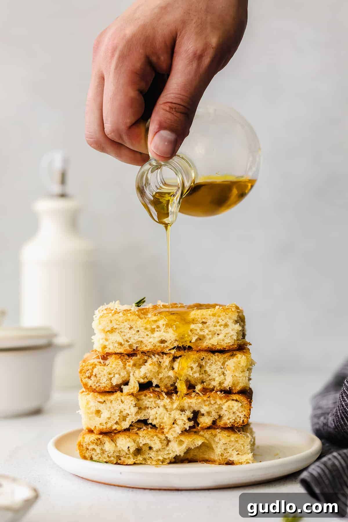 Easy Cheesy Focaccia Bread with Parmesan and Rosemary Golden focaccia bread drizzled with olive oil, topped with fresh rosemary and parmesan cheese