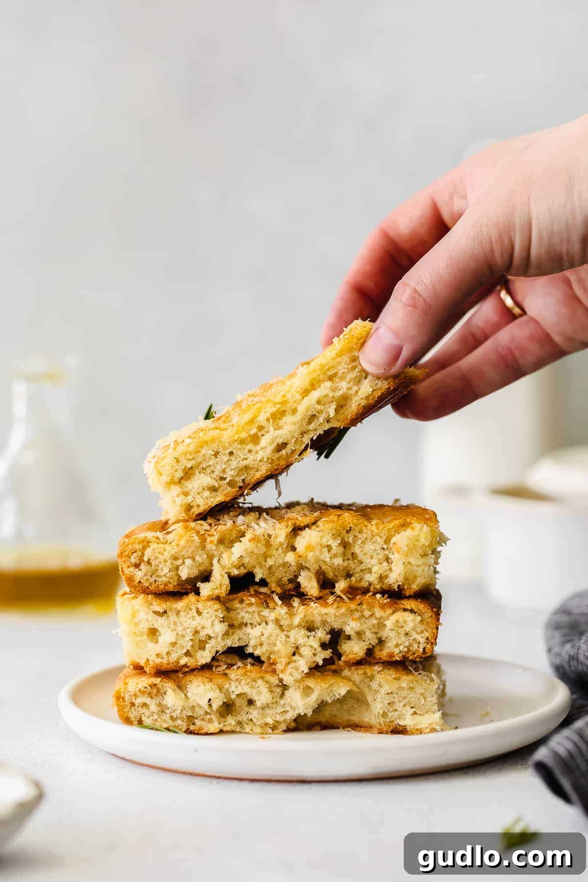 Stacked Focaccia Slices Showing Texture Stacked slices of perfectly golden focaccia bread, showcasing its fluffy, airy interior and inviting crust