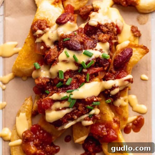 Ultimate Chili Cheese Fries 4 Close-up of fully loaded chili cheese fries, perfectly golden and covered in toppings.