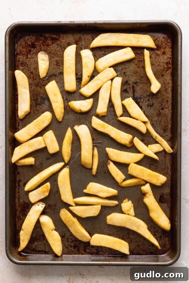 Ultimate Chili Cheese Fries 5 Potato wedges topped with chili and cheese on a baking sheet.