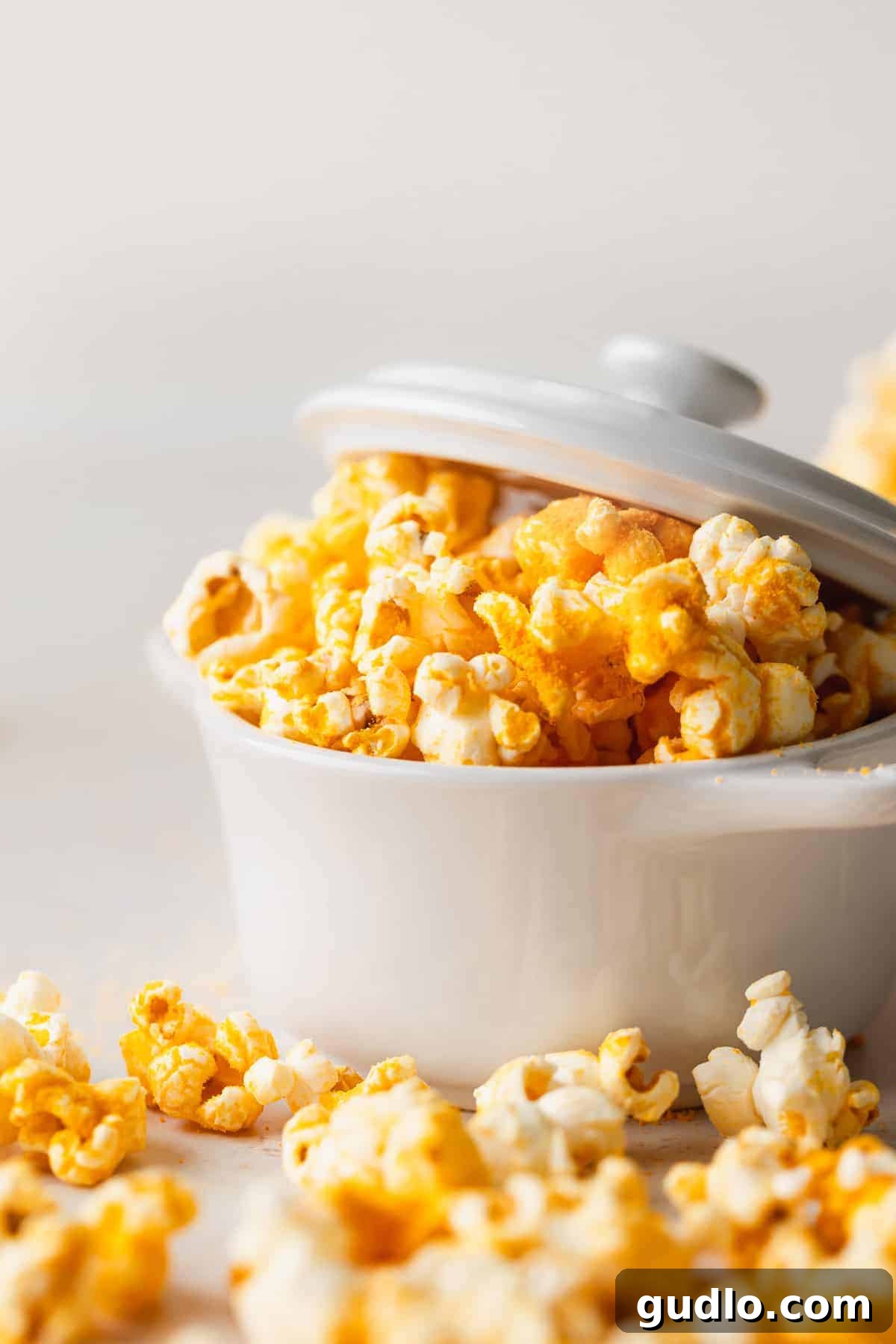 Artisanal Cheese Popcorn 2 A dish full of vibrant orange homemade cheese popcorn, ready for snacking.