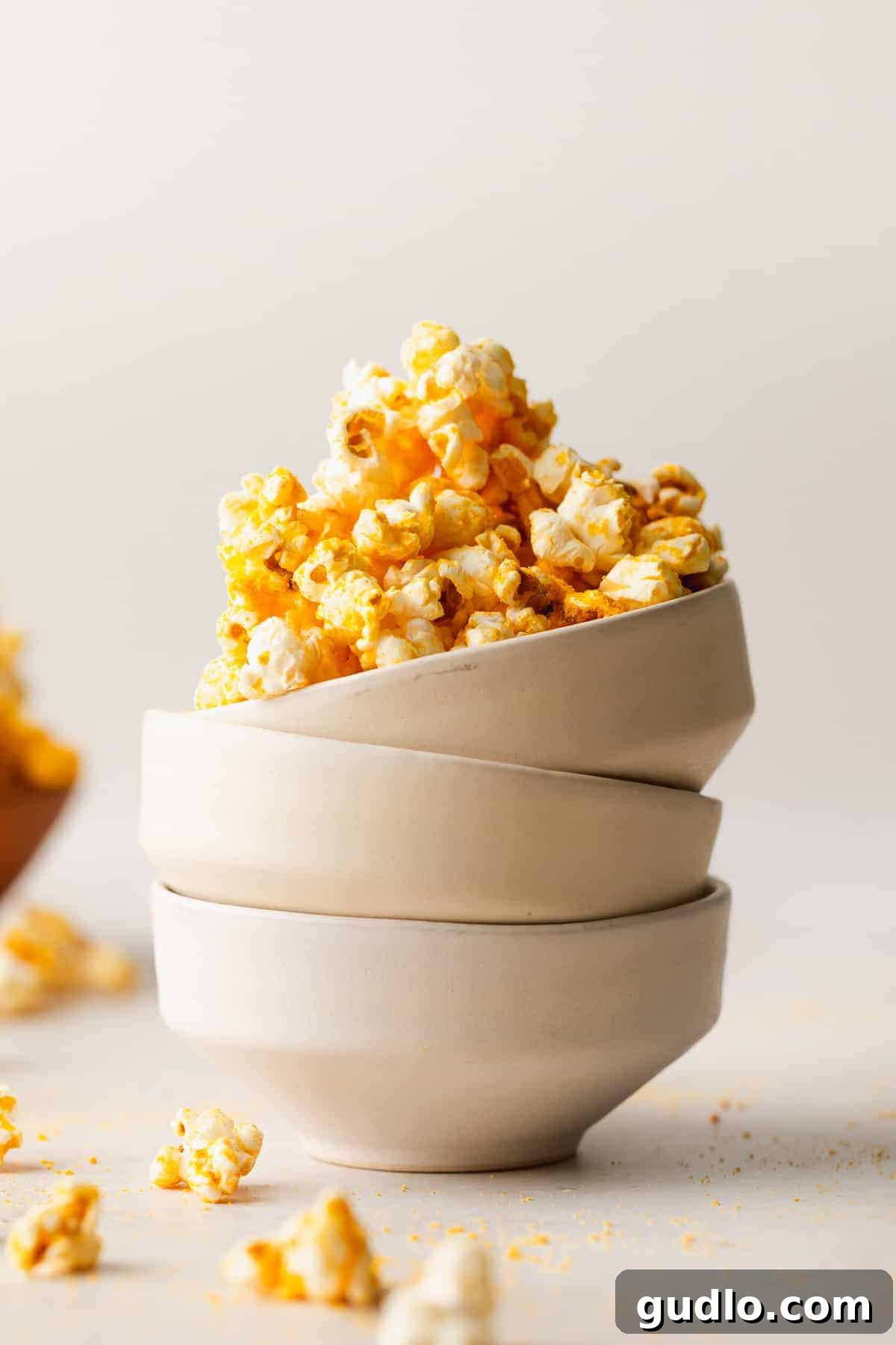 Artisanal Cheese Popcorn 5 A large batch of golden, cheesy popcorn piled high in a rustic white bowl, ready for sharing.