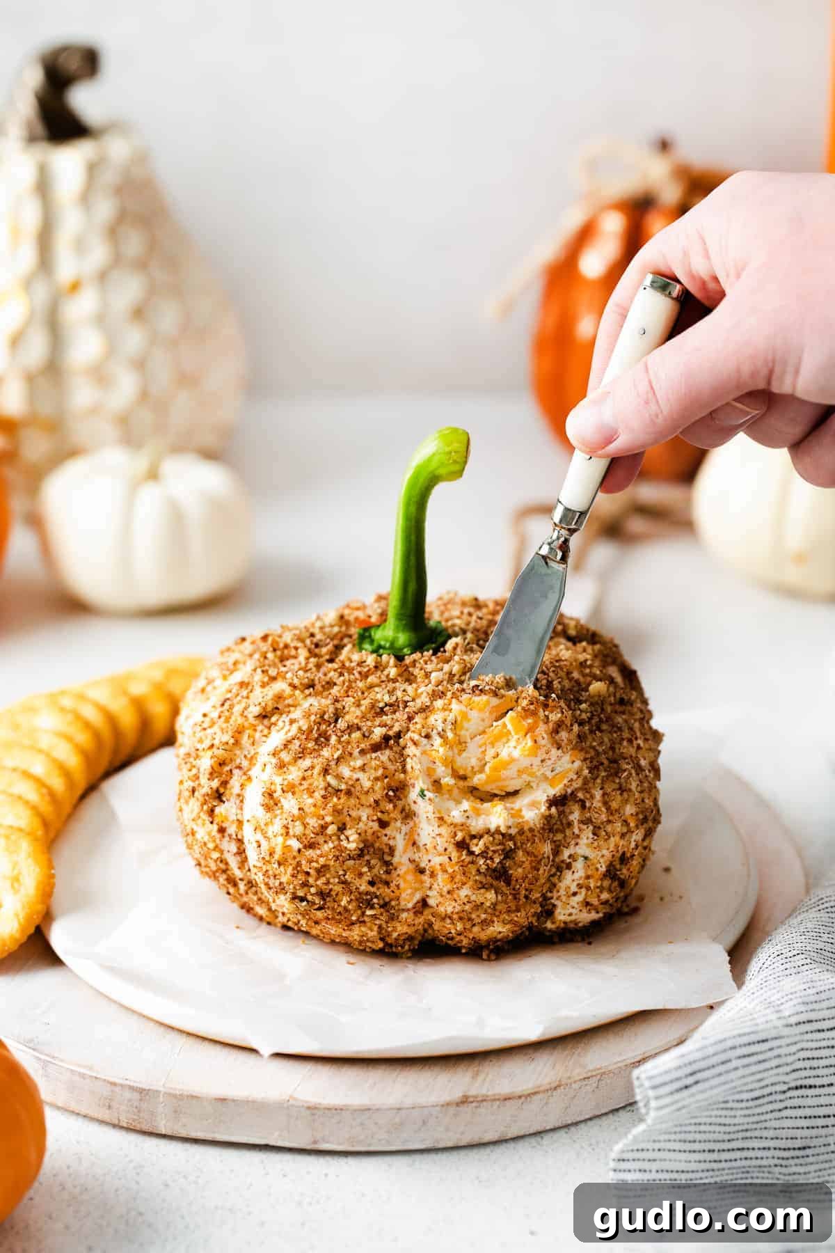 Delightful Pumpkin Cheese Ball for Fall Festivities An adorable pumpkin-shaped cheese ball, perfect for fall gatherings.