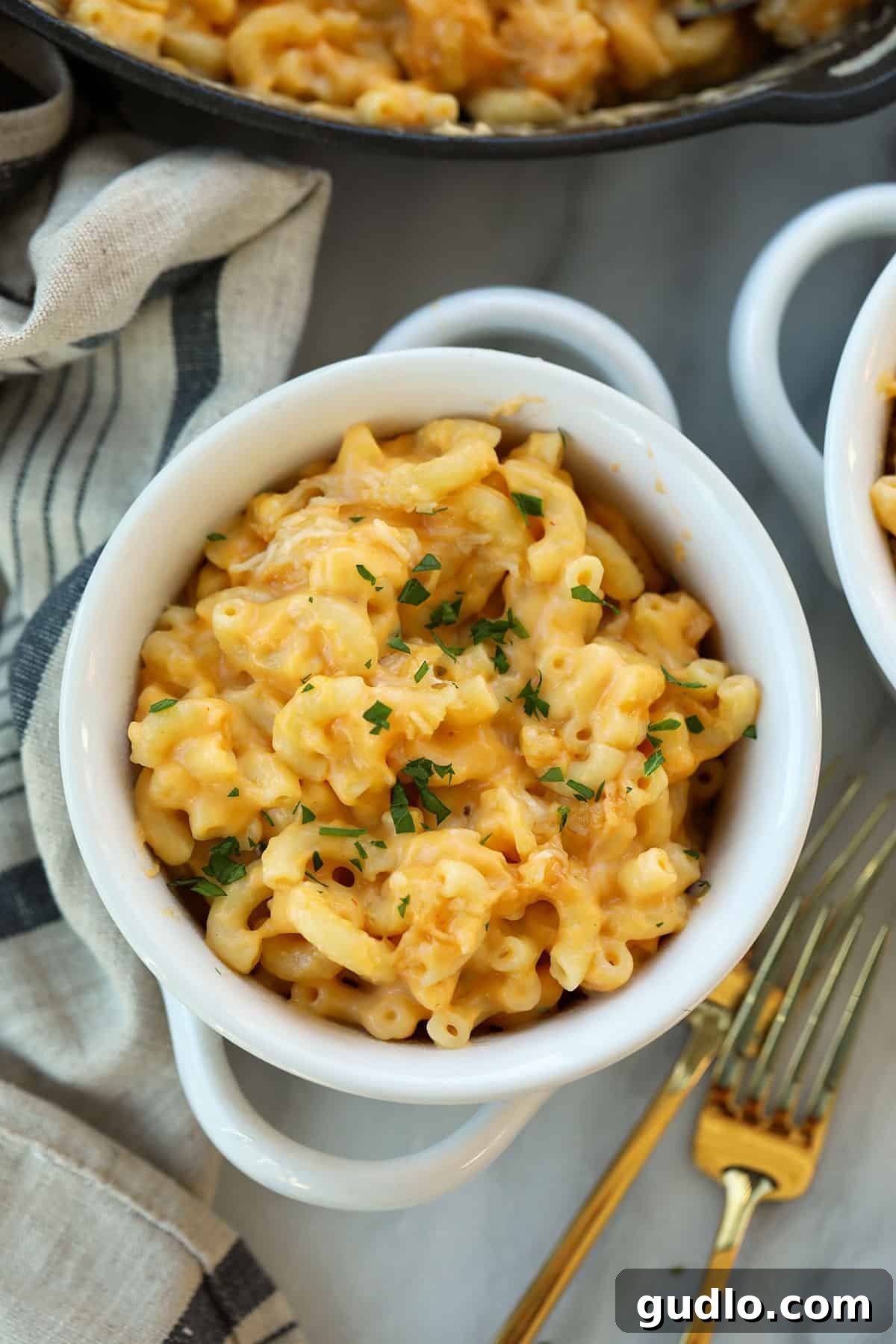 The ultimate smoked mac and cheese recipe: creamy, smoky, and ready in under an hour. Smoked mac and cheese in a bowl topped with fresh parsley.