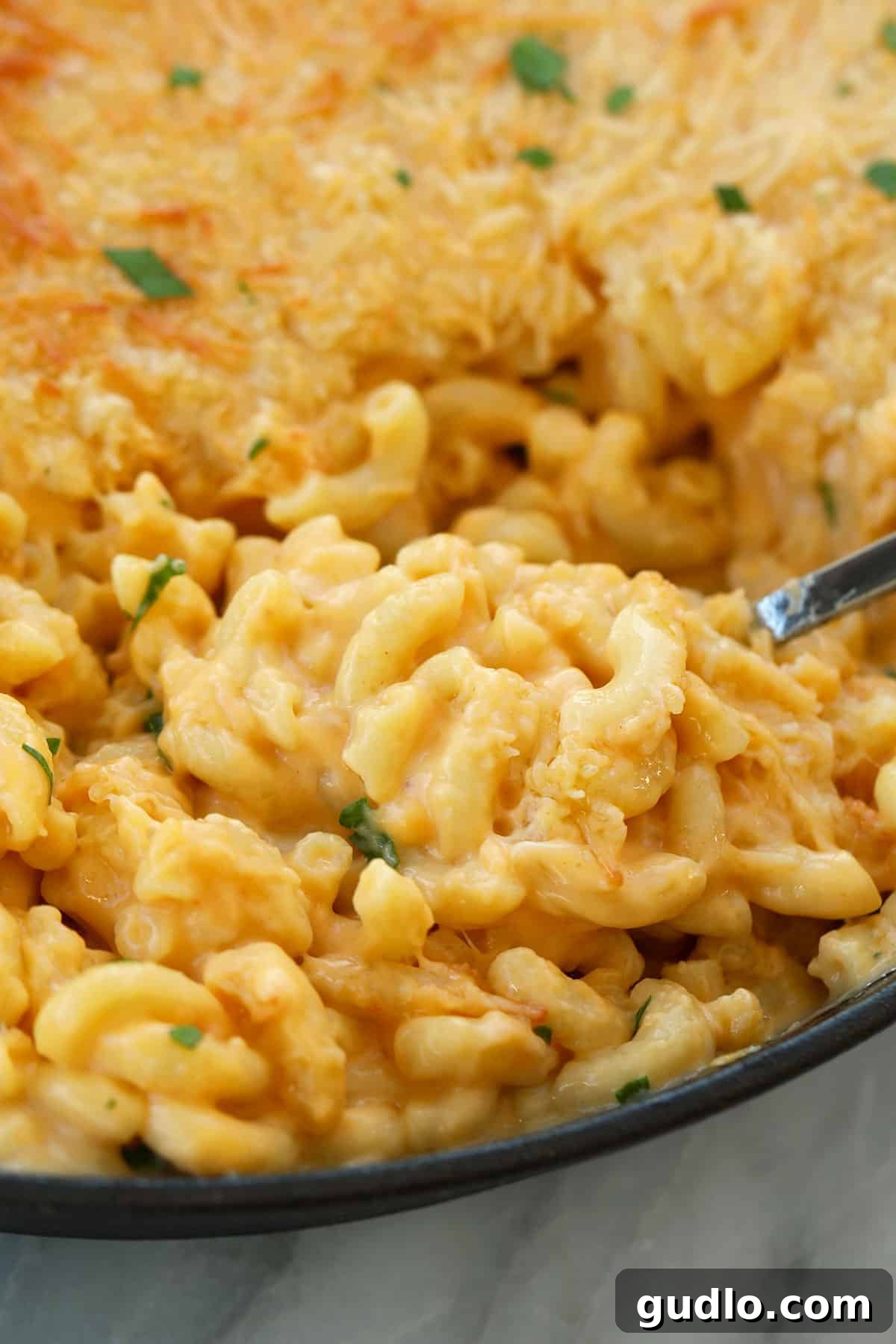 Every spoonful is a rich, smoky delight. Smoked mac and cheese on a spoon.