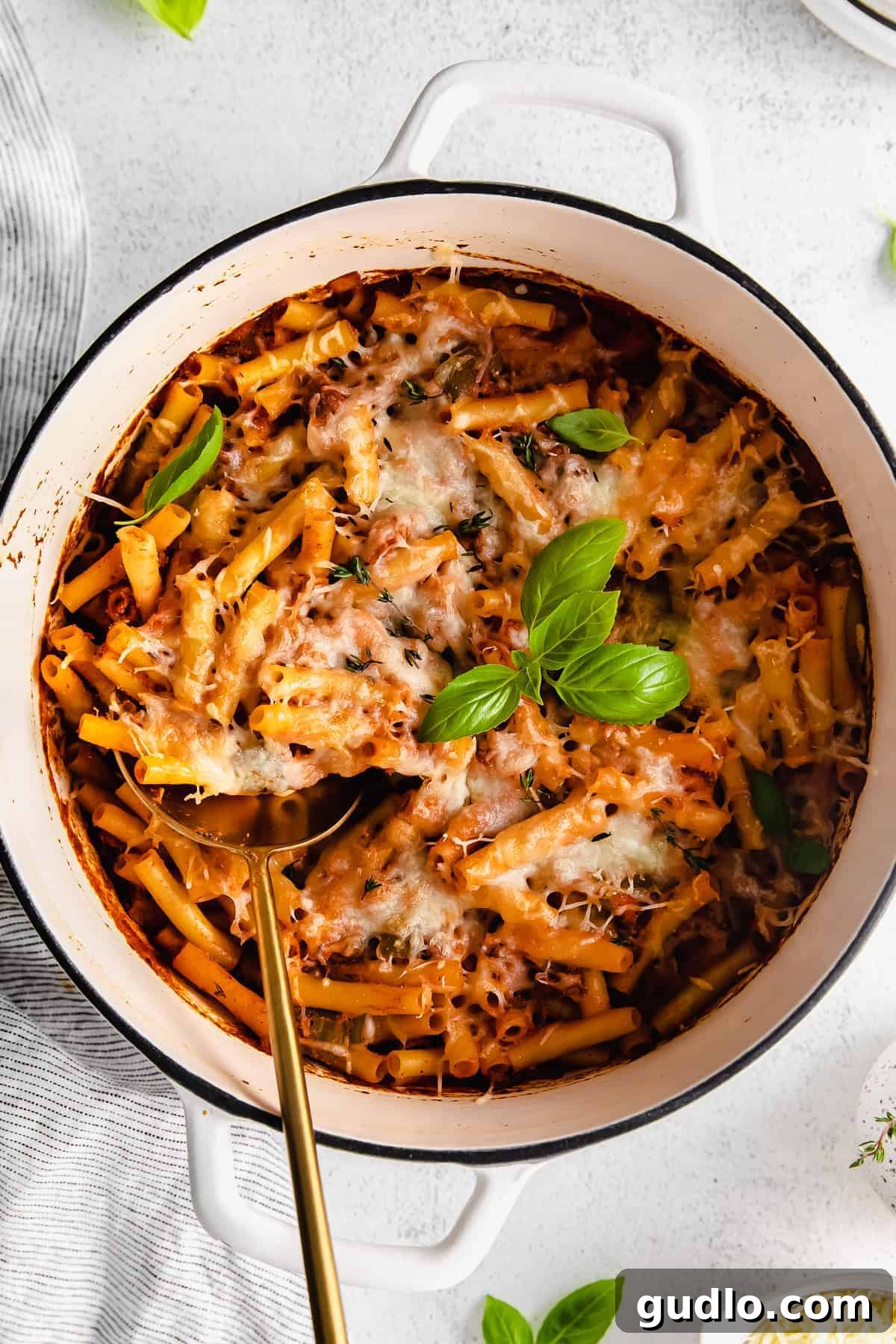 Ultimate Cheesy Ziti Bake 6 A perfectly plated bowl of baked ziti, showcasing its gooey melted mozzarella, rich meat sauce, and fresh parsley garnish.