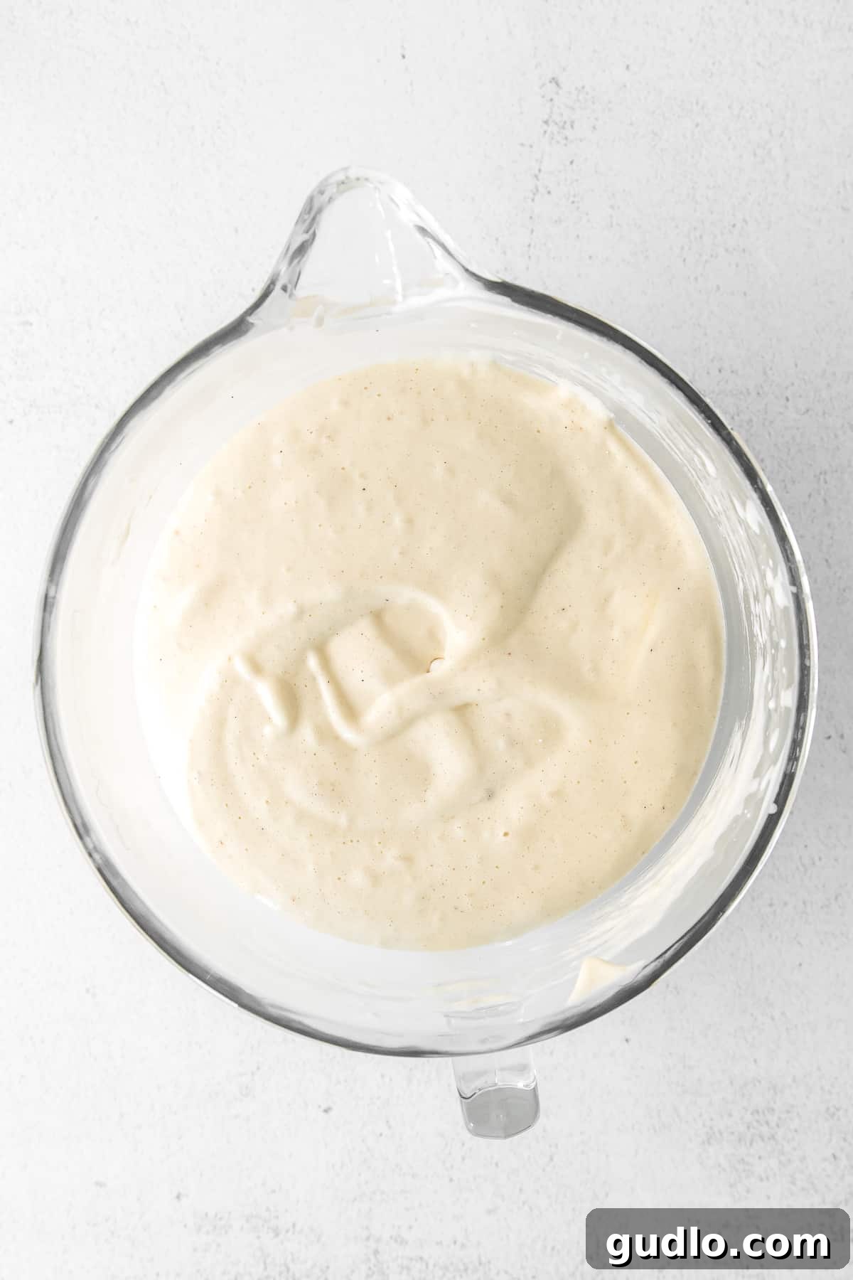 Smooth, golden-yellow Tiramisu Layer Cake batter resting in a mixing bowl, ready for baking.
