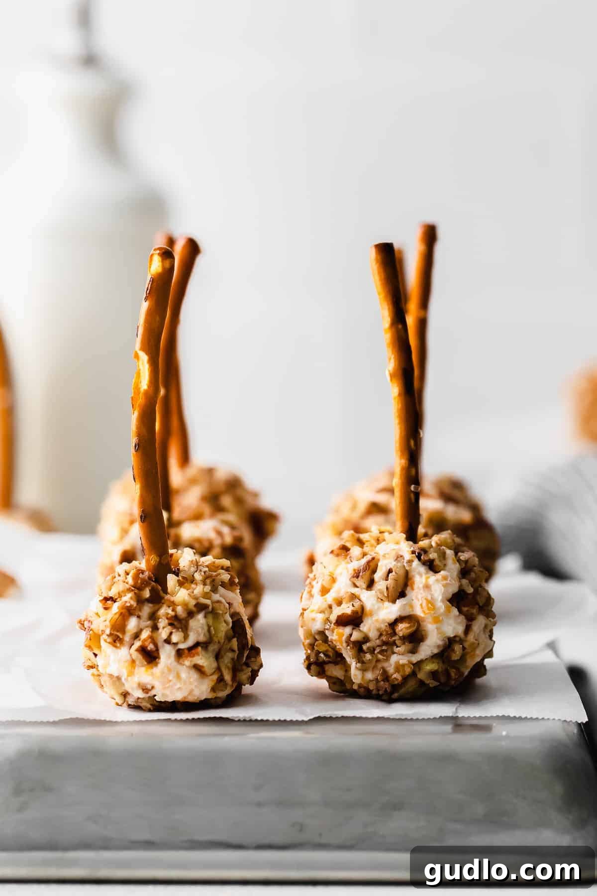 Festive Cheese Ball Bites with pretzel sticks, ready to be served