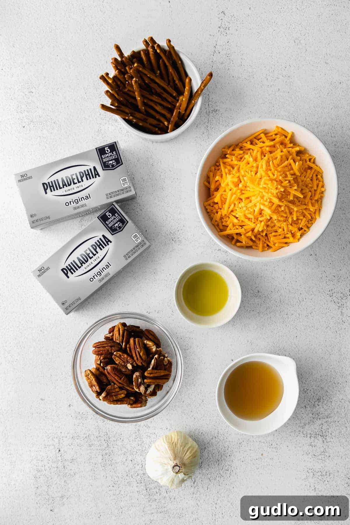 Ingredients for cheese ball bites laid out in small bowls, ready for mixing