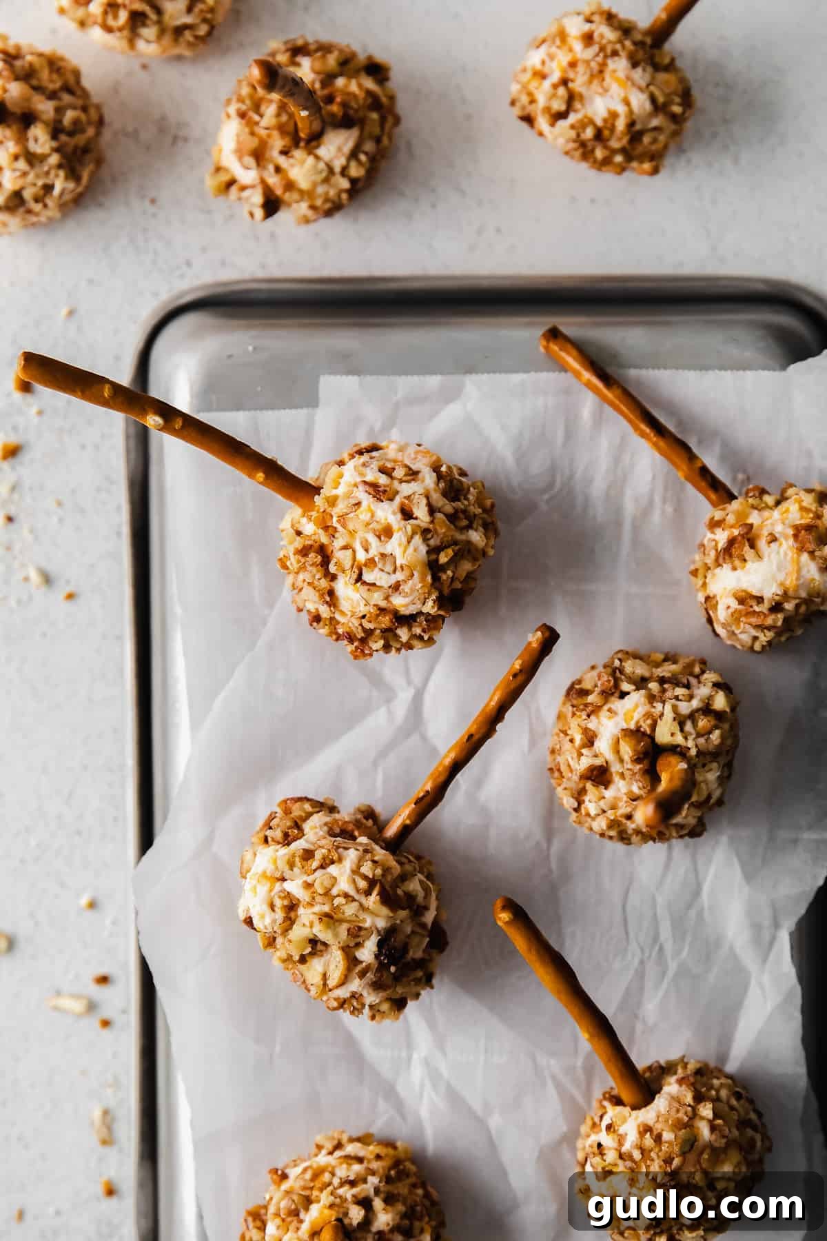 Cheese ball bites arranged neatly on a piece of parchment paper
