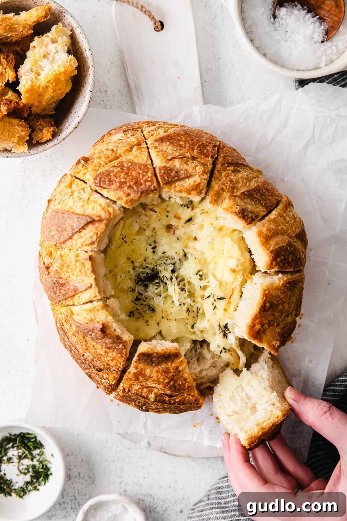 Sourdough baked brie is a fun twist on classic baked brie. Bake the brie inside a fresh loaf of sourdough and use the sides to scoop the cheesy deliciousness. Baked brie in bread