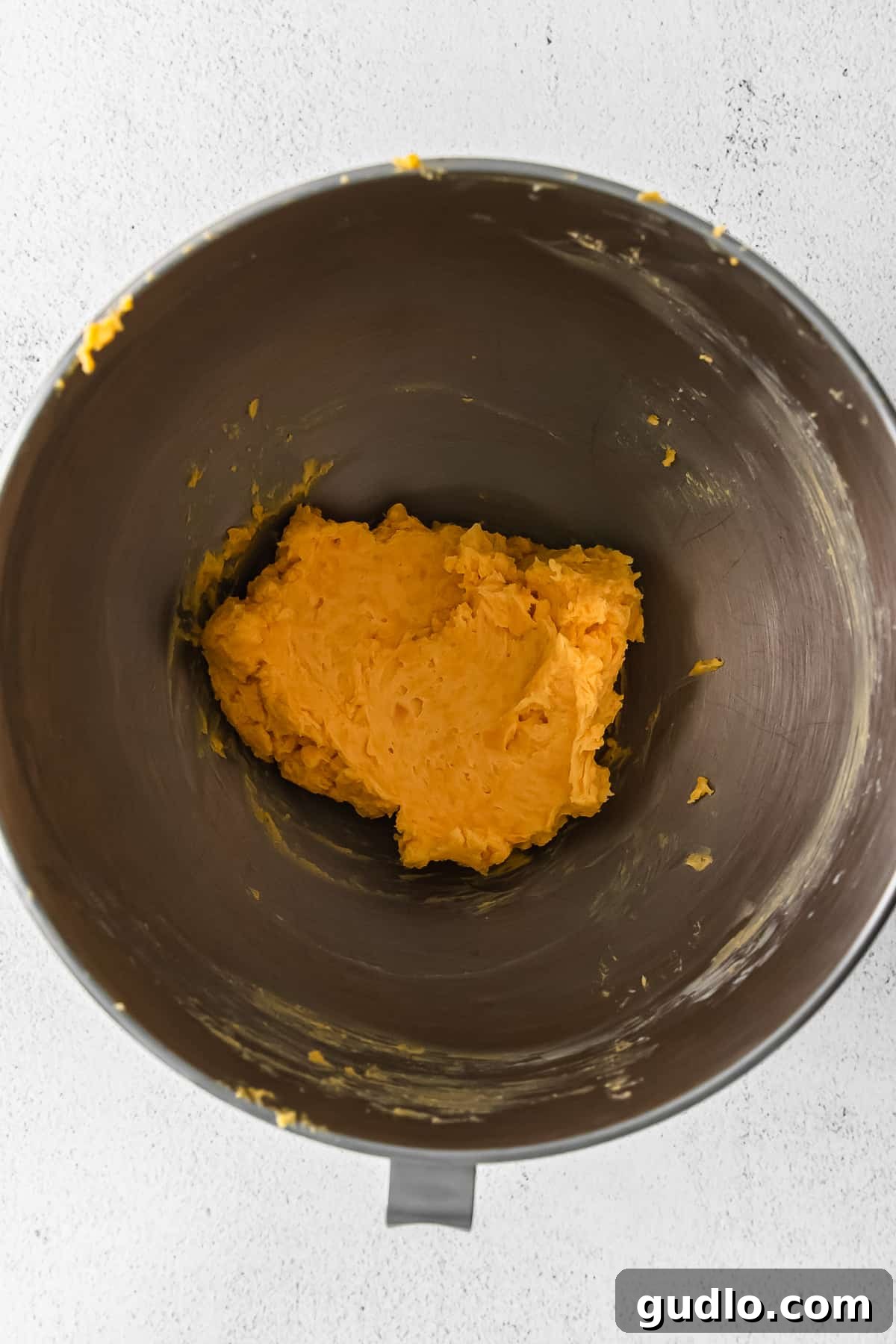 Crunchy, perfect homemade Cheez Its only require a few ingredients -- including real cheddar cheese! Learn how to make them in this post. Close-up of freshly mixed Cheez-It dough in a mixing bowl, showing its crumbly texture.