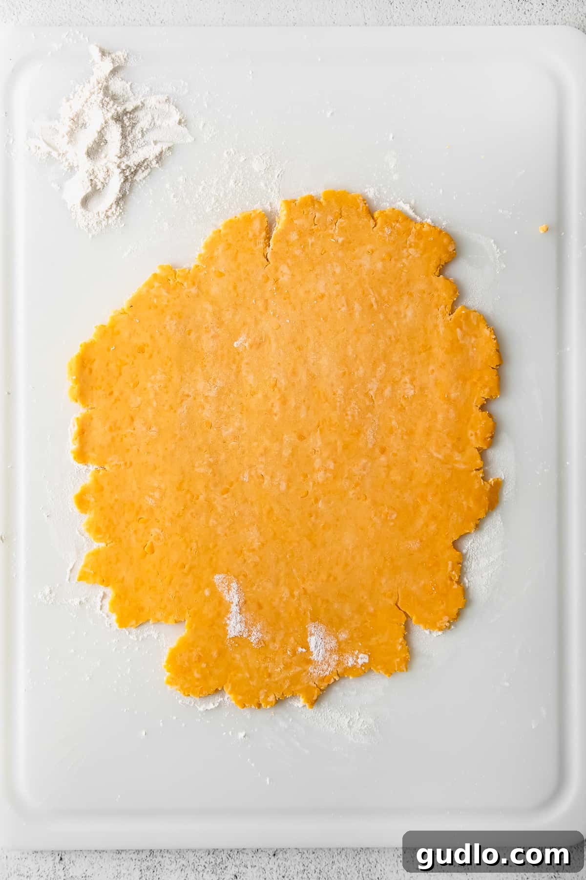 Crunchy, perfect homemade Cheez Its only require a few ingredients -- including real cheddar cheese! Learn how to make them in this post. Thinly rolled Cheez-It dough on parchment paper, ready to be cut into squares.