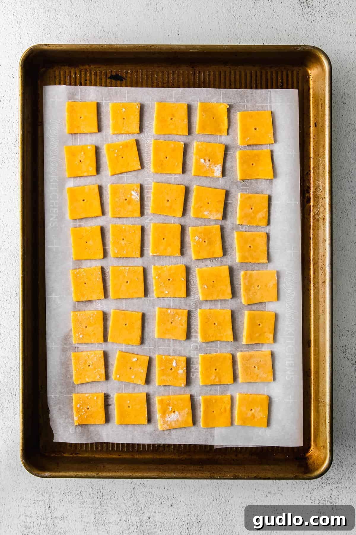 Crunchy, perfect homemade Cheez Its only require a few ingredients -- including real cheddar cheese! Learn how to make them in this post. Homemade Cheez-Its cut into perfect squares on a baking sheet, ready for the oven.