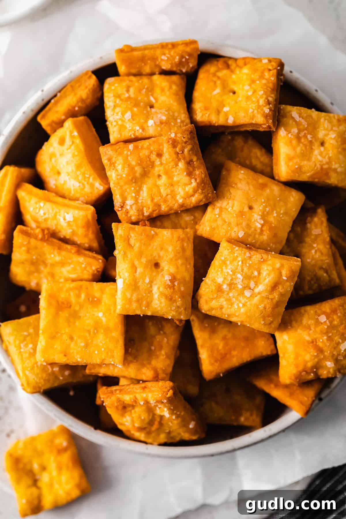 Crunchy, perfect homemade Cheez Its only require a few ingredients -- including real cheddar cheese! Learn how to make them in this post. A bowl brimming with delicious homemade Cheez-Its, ready for snacking.