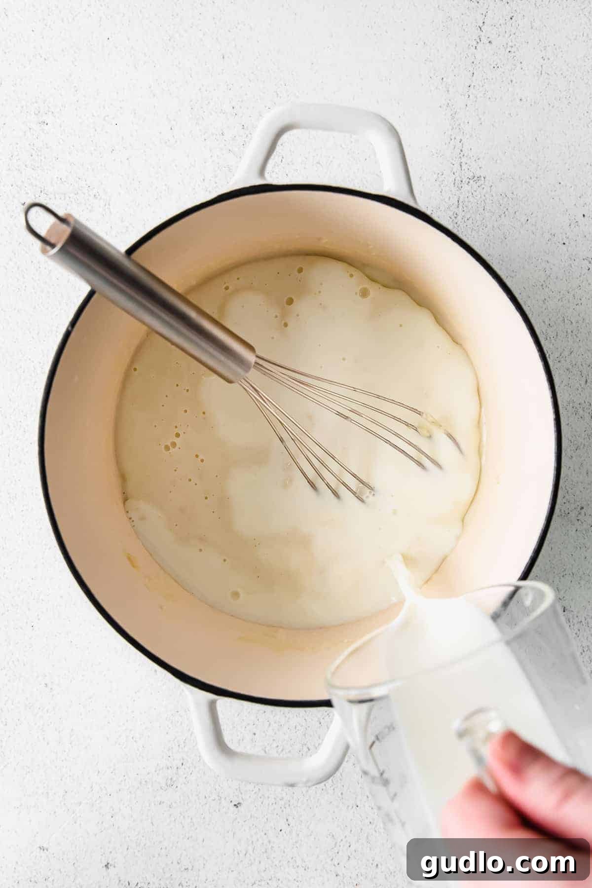 Our Ultimate Velveeta Cheese Sauce is oh so creamy and flavorful and made with easy ingredients. Pair with your favorite pasta, and enjoy! Preparing a golden roux in a stock pot for Velveeta cheese sauce