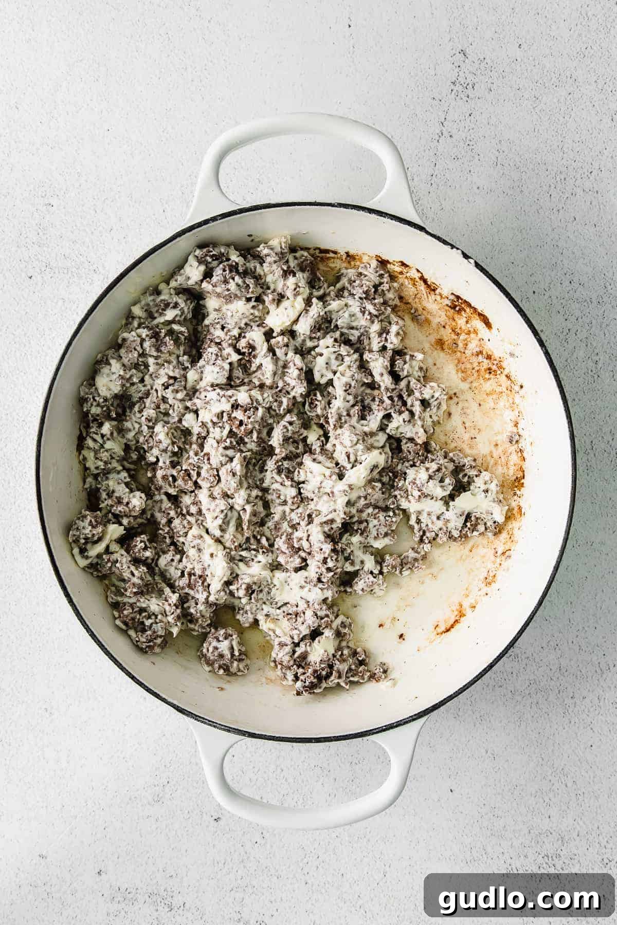 Oven-Baked Cheesy Jalapeño Dip 5 Ground beef and cream cheese melding together in a hot skillet, forming the creamy base of the jalapeño popper dip.