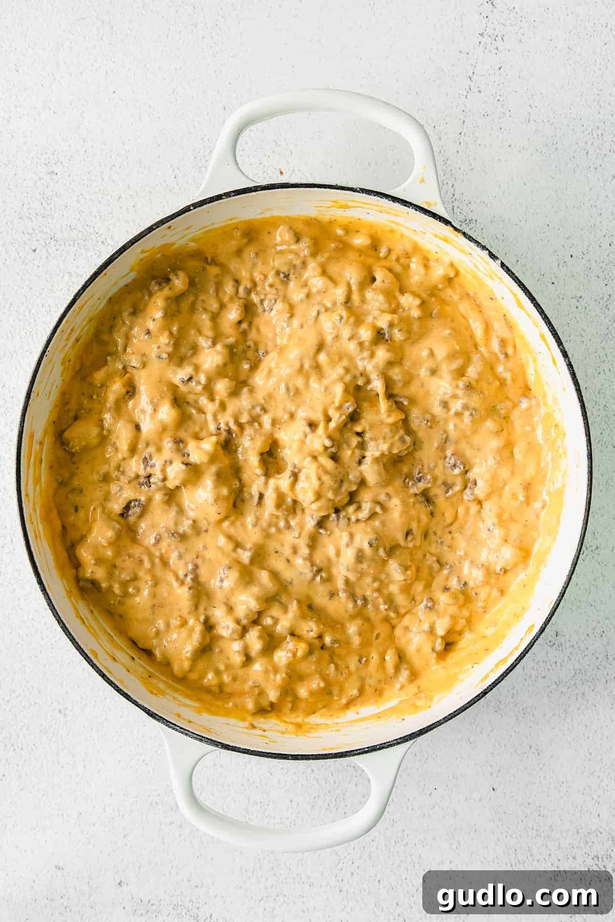 Oven-Baked Cheesy Jalapeño Dip 6 A large pot of hot, bubbly Jalapeño Popper Dip served in a dutch oven, garnished with fresh herbs, ready for sharing.
