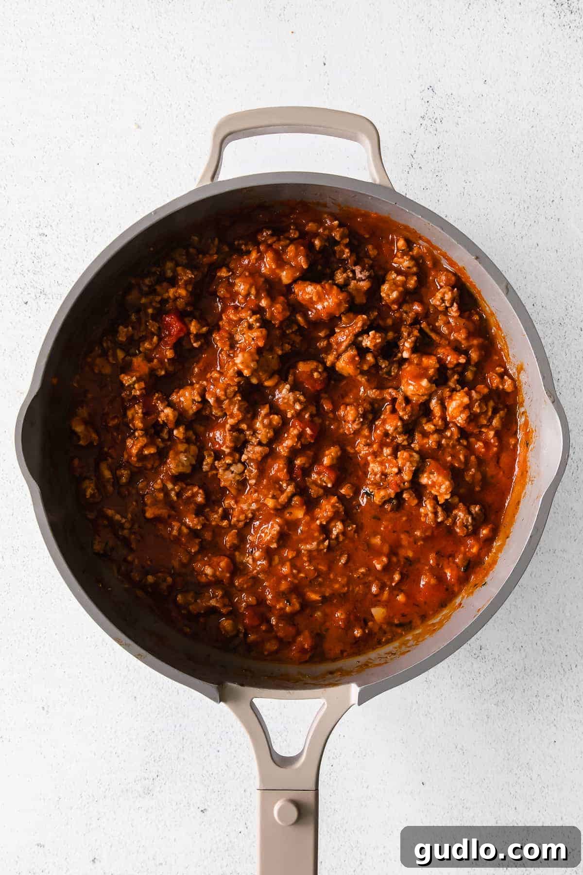 Skillet Lasagna Bake 4 Sizzling ground beef and Italian sausage cooking in a skillet, browning beautifully