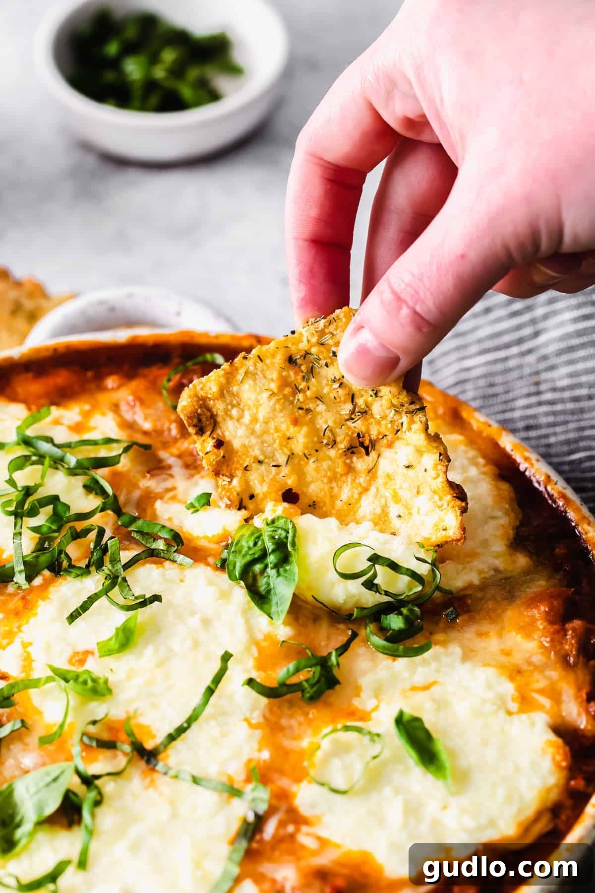 Skillet Lasagna Bake 7 Air fryer pasta chip loaded with rich lasagna dip, ready to be enjoyed