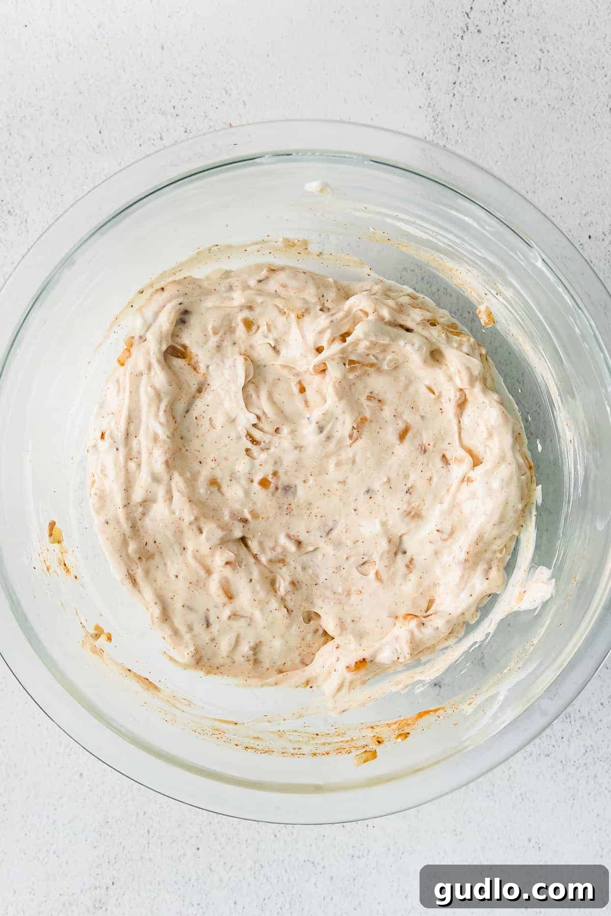 Ultimate Cheesy Crab Dip 5 A large mixing bowl filled with creamy dip ingredients, ready for crab meat and cheese to be folded in.