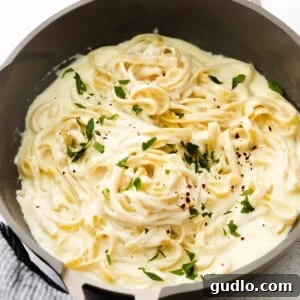 A close-up of a perfectly thickened pasta sauce, rich and glossy, clinging beautifully to the pasta.