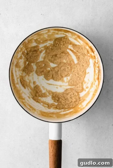 A frying pan showing the butter and flour roux for cheese sauce.
