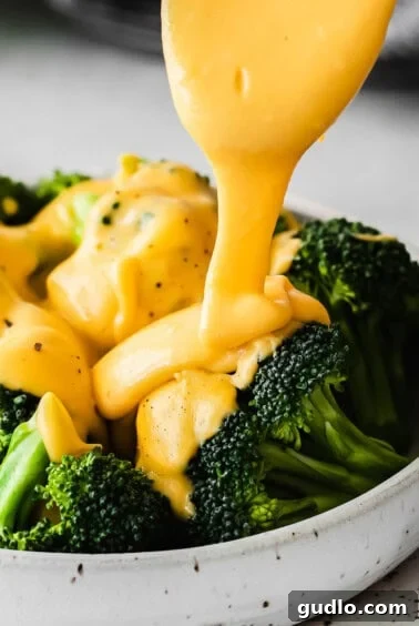 Close-up of creamy cheese sauce for broccoli, perfect for dipping.